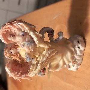 Available - Vintage Seraphim Angel holding a child figurine.